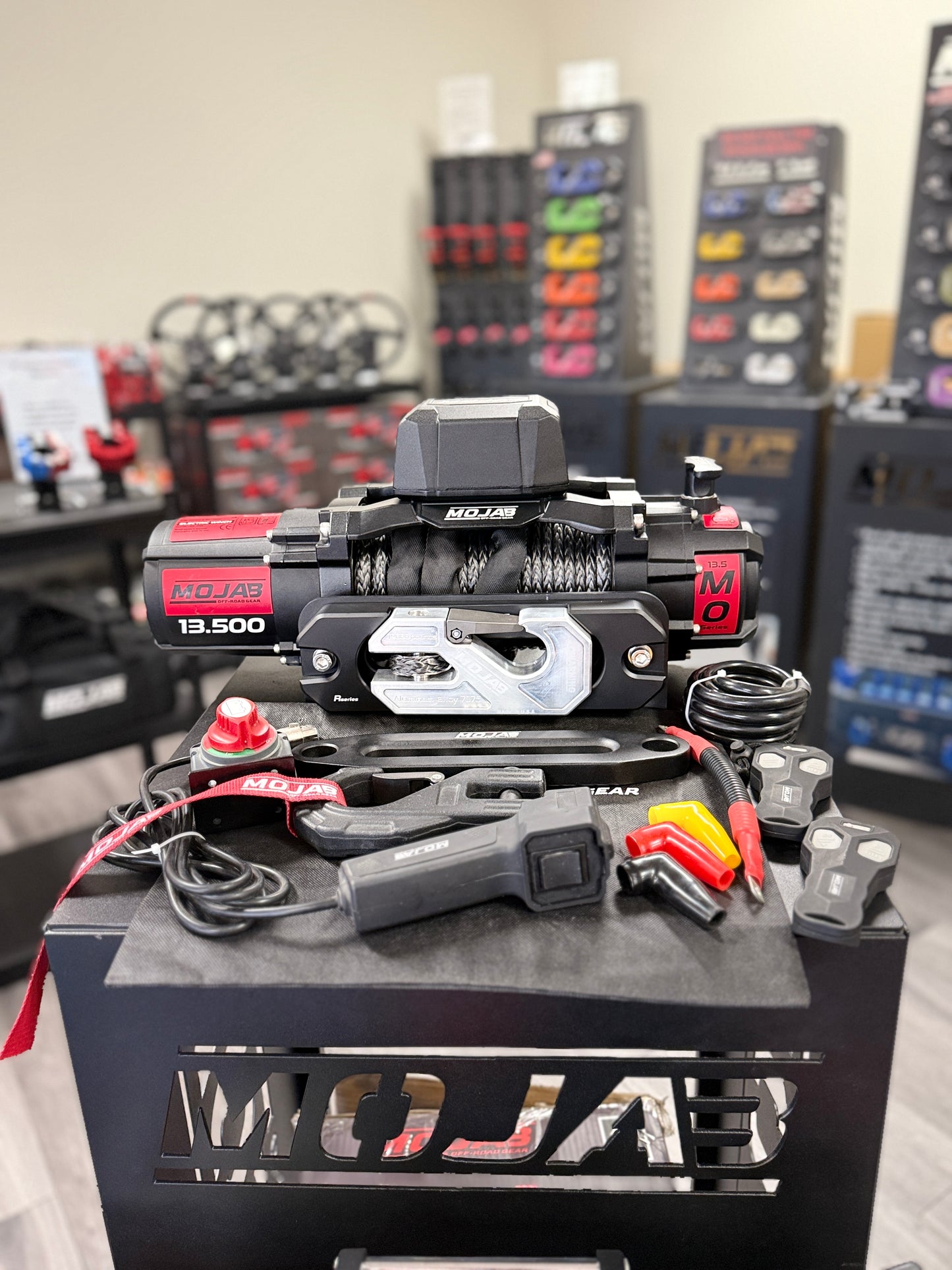 MOJAR winch and related equipment on a stand , remote control and shackle and winch line.